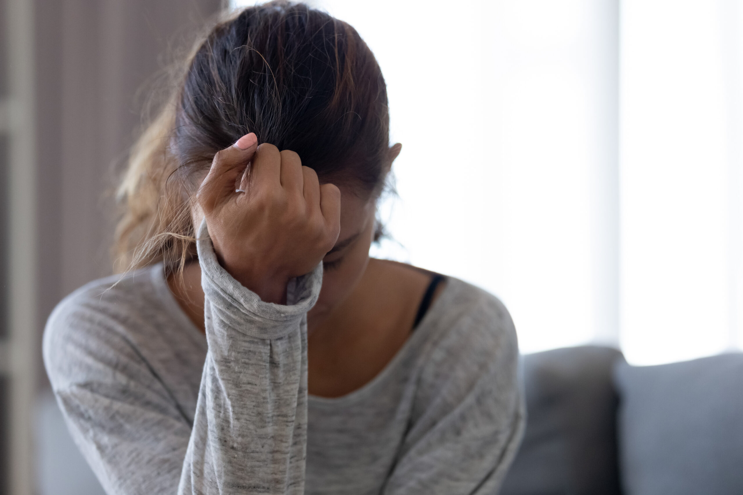 Depressed upset young woman feeling hurt sad stressed troubled with unwanted pregnancy, regret mistake abortion, having headache or drug addiction, suffer from grief dramatic bad problem concept